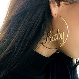 Large gold hoop earrings with the word "baby"